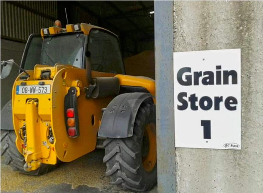 yellow-farm-equipment-parked-in-grain-store
